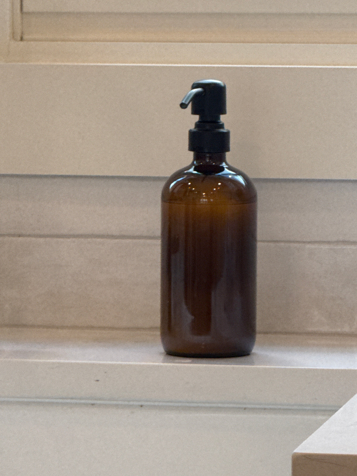 Brown Glass and Black Soap Dispenser
