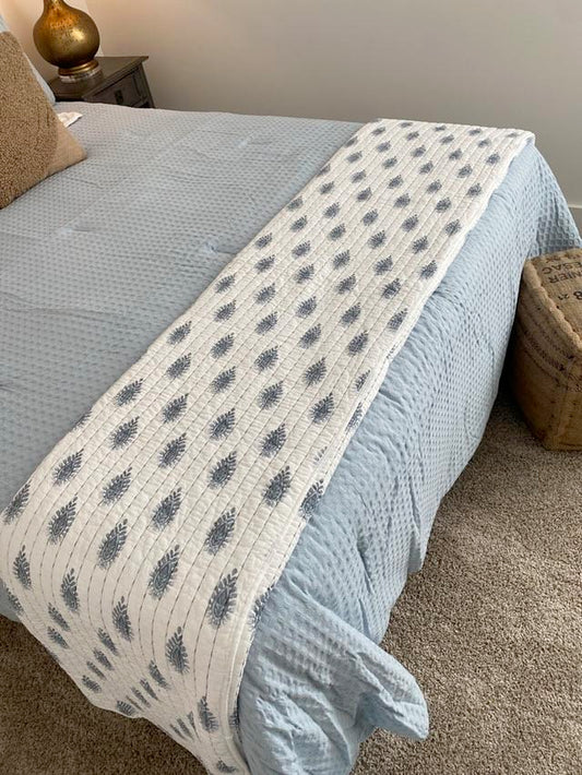 Blue and White Patterned Quilt